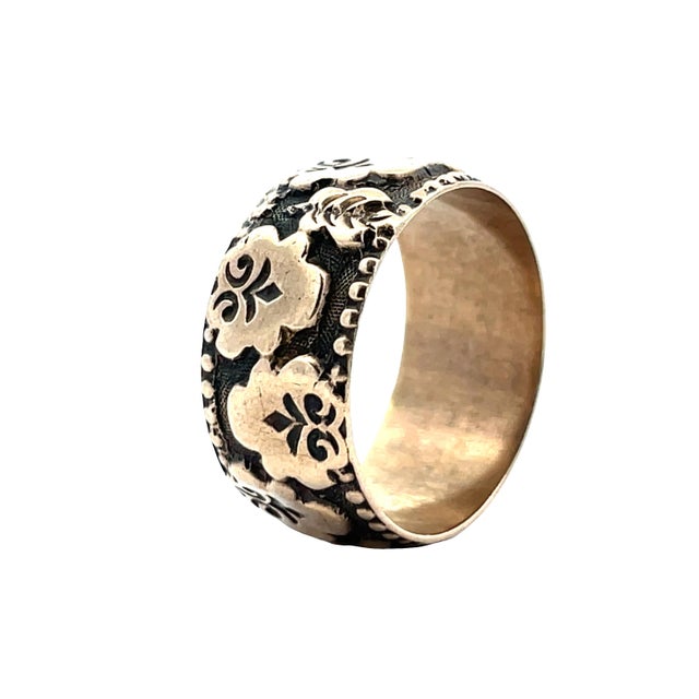 Classic 10K yellow gold vintage band ring featuring an intricate floral and scroll engraved pattern with darkened...