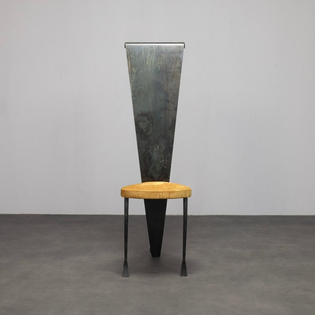 An expressive postmodern chair that blurs the line between furniture and sculpture. The dramatically elongated backrest...