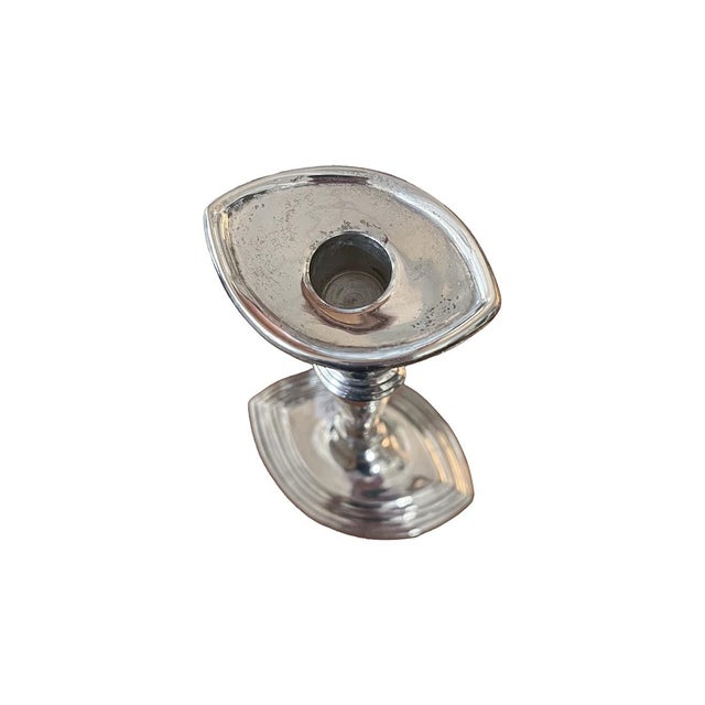 This pair of silver-plated candlesticks is of neoclassical style. They are fluted, with oval bases. The bases feel...