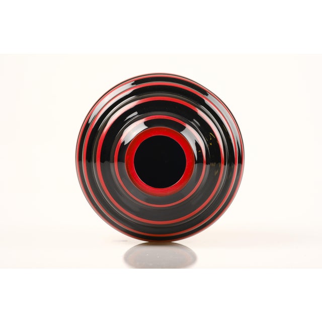 Handmade black opaline glass vase with red hand-painted decor, by Åfors. This piece was made in Sweden during the 1920s,...