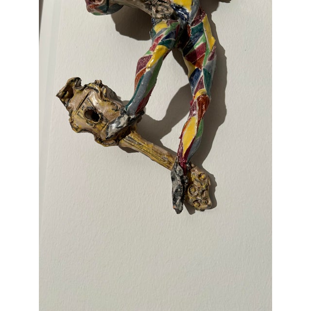 A dynamic wall sculpture in polychrome Albissola ceramic, dating back to 1960, by Anselmo. This work captures a female...