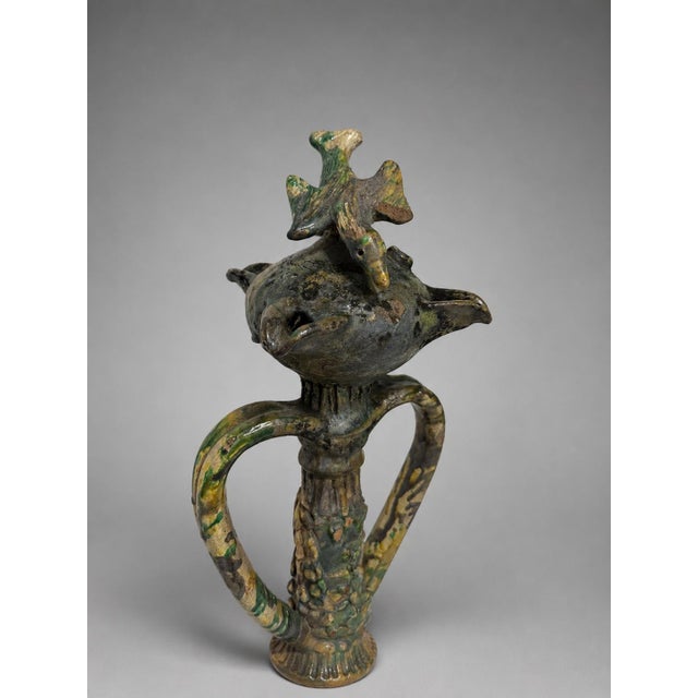 This unusual sculptural glazed earthenware object is best cataloged as an antique French épi de faîtage, or roof-ridge...