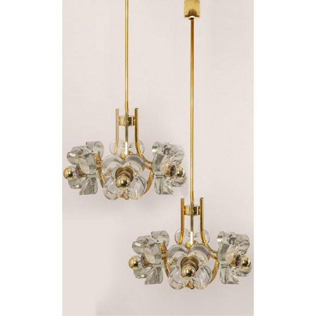 This ceiling light was designed by simon and schelle, featuring a rectangular brass base and six massive glasses in the...