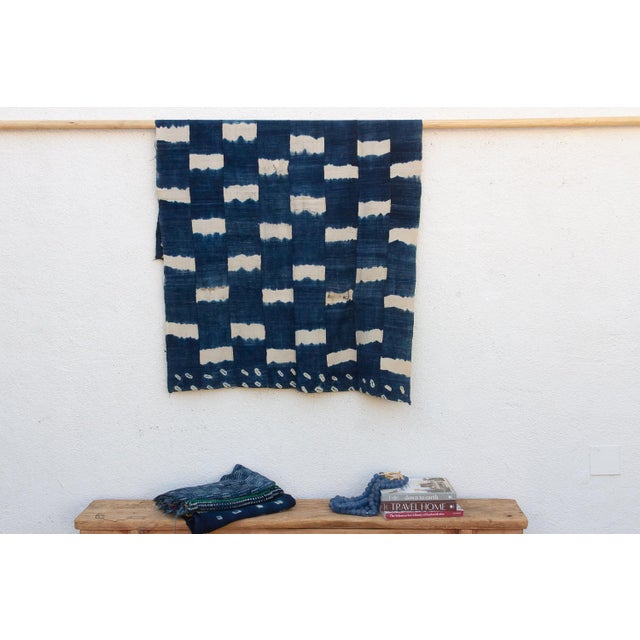 A masterwork of Malian textile heritage featuring deep indigo saturation and symbolic geometric motifs. Originating from...