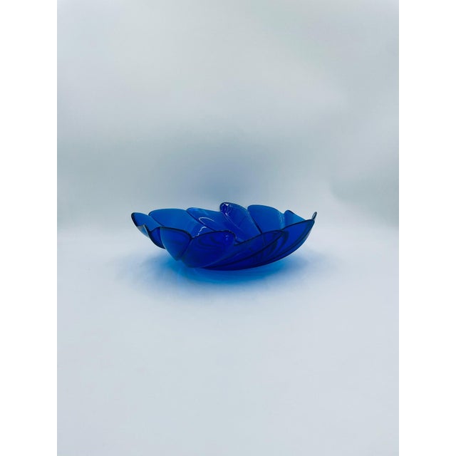 A large vintage-style serving bowl made of high-quality glass. The bowl, in a deep cobalt blue, is distinguished by its...