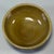 This compact ceramic bowl has warm olive‑brown glazed surface with subtle texture. The base is neatly finished. It is...