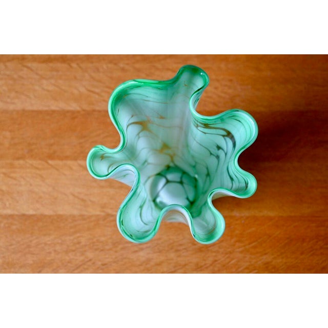 Free form, indecisive and vaporous like a cloud, this large handkerchief vase is made of two-tone white and green glass....