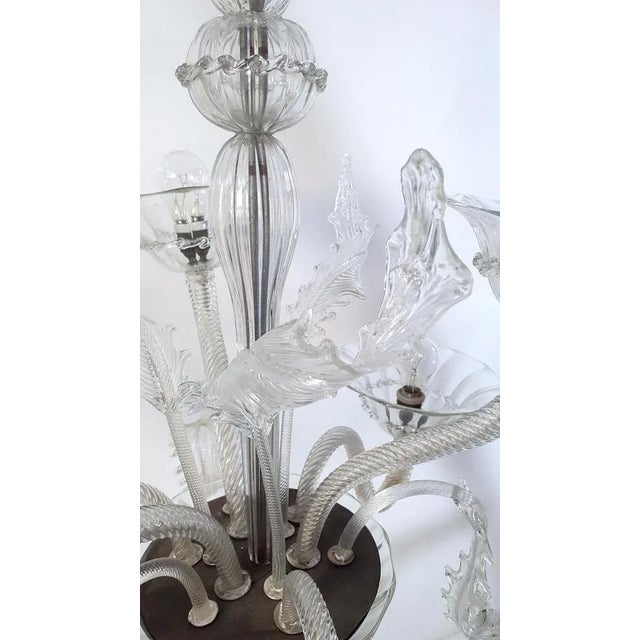 This is a very nice example of a classical chandelier from Murano in the Venetian style in clear glass with six arms for...