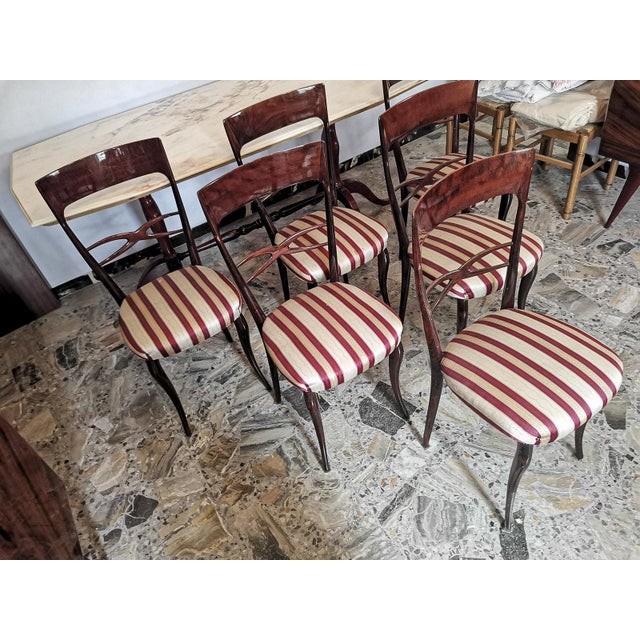 Set of 6 chairs in creamy white and burgundy red fabric and wood, vintage, well maintained. Measurements: 44 x 43 x h 95 x...