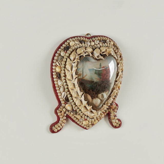Charming antique sailor valentine handcrafted in exotic seashells in heart form with an image of a sailing ship as seen...