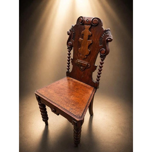 A highly decorative antique solid oak hall chair, dating to the late Victorian period, circa 1880–1900, and displaying...