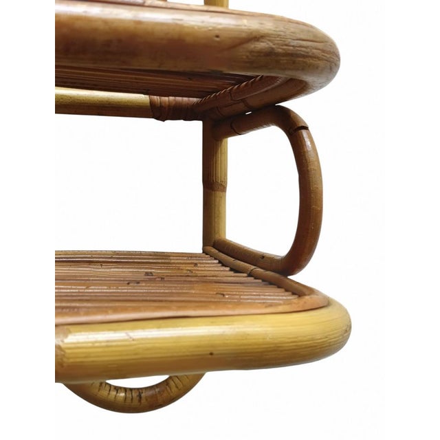 A beautiful two-tier wall-mounted shelf/bedside table in bamboo and rattan, in the style of Franco Albini. Made in Italy...