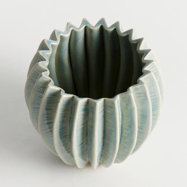 With a rounded form, deep ribbing and thickly applied glaze, this natureinspired pot is a work of art. The handfinished...