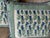 A pair of pillows made from hand stitched petit point, backed and trimmed with coordinating velvet