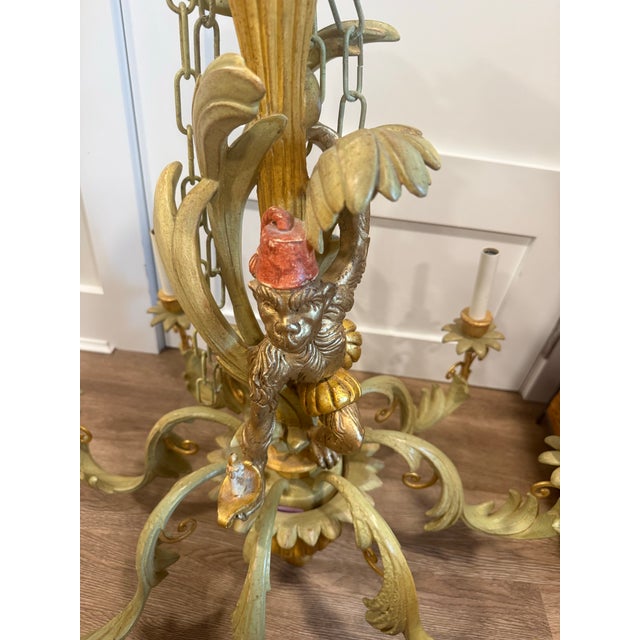 A whimsical and truly special piece of Italian lighting — this mid-century tole chandelier centers on a playful monkey...