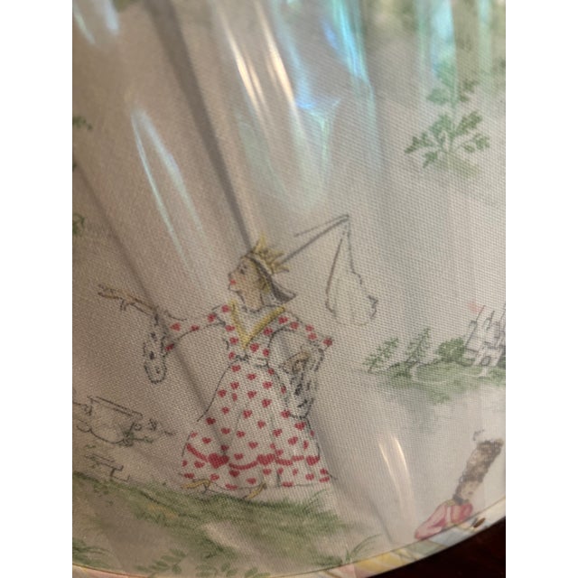 Child’s nursery rhyme lampshade featuring renderings of various rhymes such as “the cow jumping over the moon, humpry...