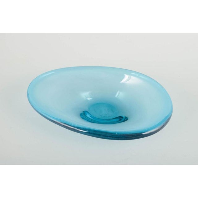 Scandinavian glassworks Art glass bowl, 1970s. Organically shaped, mouth-blown bowl in turquoise blue glass with thick...