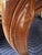 Elegant armchair with a carved wood frame and cream-colored damask upholstery. The chair has a scalloped backrest and...