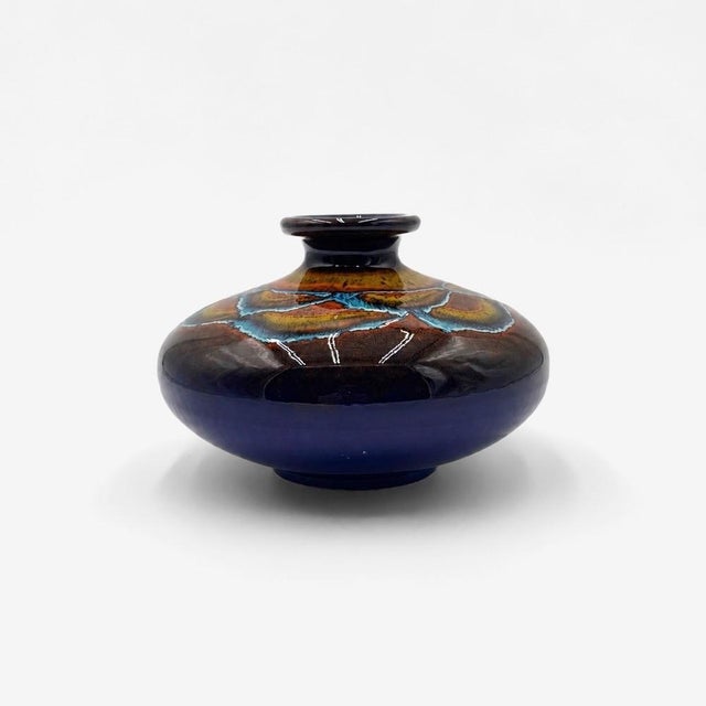 with its low, generously rounded, almost pebble-like silhouette, this captivating ceramic vase plays as much on volume as...