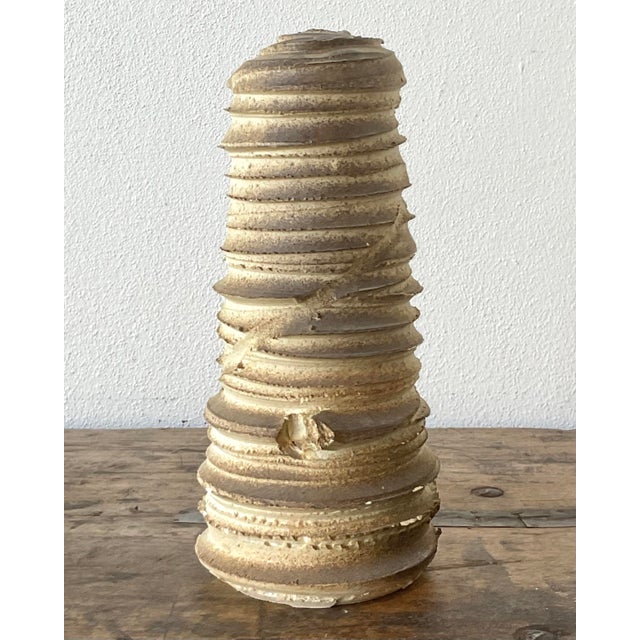 This vintage studio pottery vase is a striking example of Brutalist design, perfect for the collector seeking organic,...