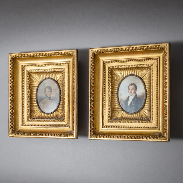 Pair of oval miniature portraits of gentlemen in matching gilt frames. The portraits are executed on oval porcelain...