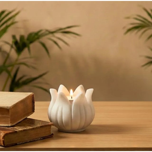 Elevate your sanctuary with the tranquil grace of our Hand Carved White Marble Lotus Tea Light Holder, a true testament to...