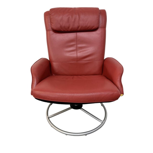 The Vintage 1999 IKEA Red Vinyl Swivel Lounge Chair is a stylish and comfortable accent chair for adults. This modern and...