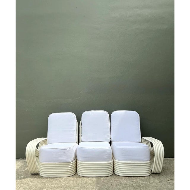 This vintage Paul Frankl six-strand white rattan sofa is an iconic masterwork of mid-century tropical modernism, its...