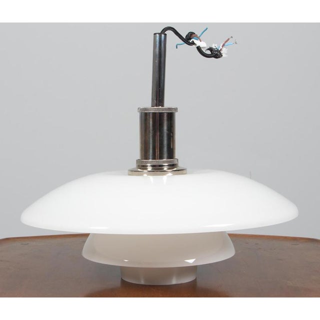 Poul Henningsen pendant lamp in chrome and opal glass. Model 4½/4, made by Louis Poulsen. This piece is attributed to the...