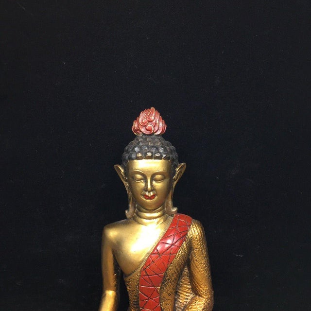 This is a vintage gilt bronze figure of a seated Buddha. The statue features a serene expression with downcast eyes and a...
