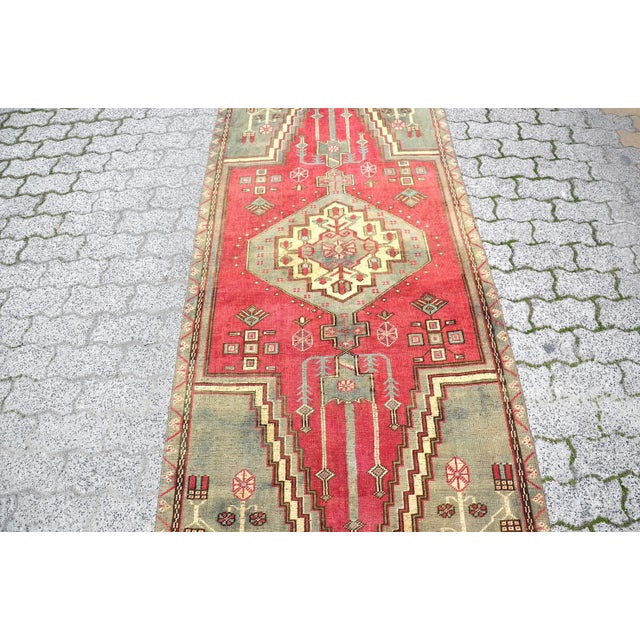 This is a vintage Turkish Oushak rug from the 1960s. The piece was hand-knotted.