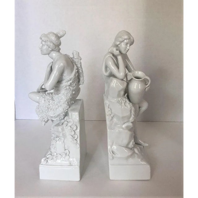 This set of allegorical figurines date to the early part of the 20th century and depict a young teen with a bow and arrow...