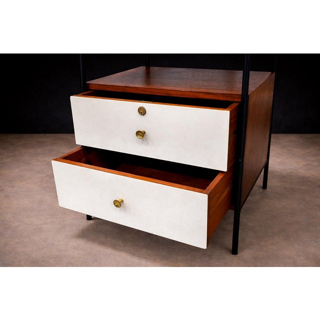 A refined study in contrast and proportion, this side table balances a warm timber volume within a slender blackened metal...