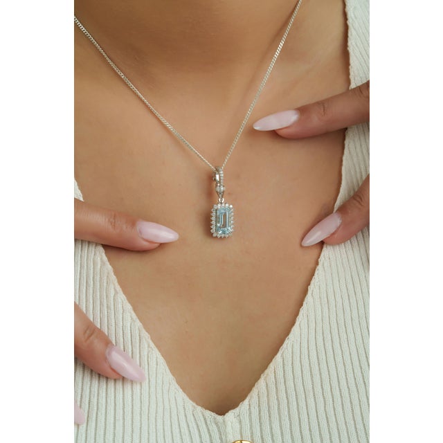 This elegant pendant showcases a 1.90 carat Ice Blue Aquamarine set in 14k white gold. The center stone measuring 10 x 5.7...