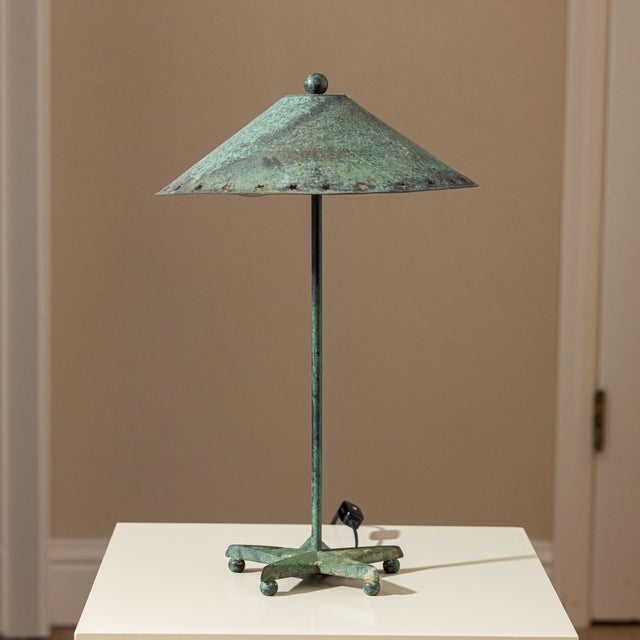 Sculptural vintage table lamp featuring a beautifully aged verdigris patina, broad conical shade with star-shaped...