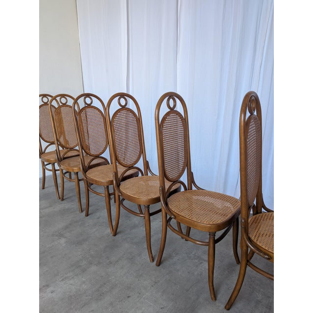 Set of 6 vintage bentwood dining chair in the classic Thonet style, featuring a high cane backrest and cane seat. Made in...