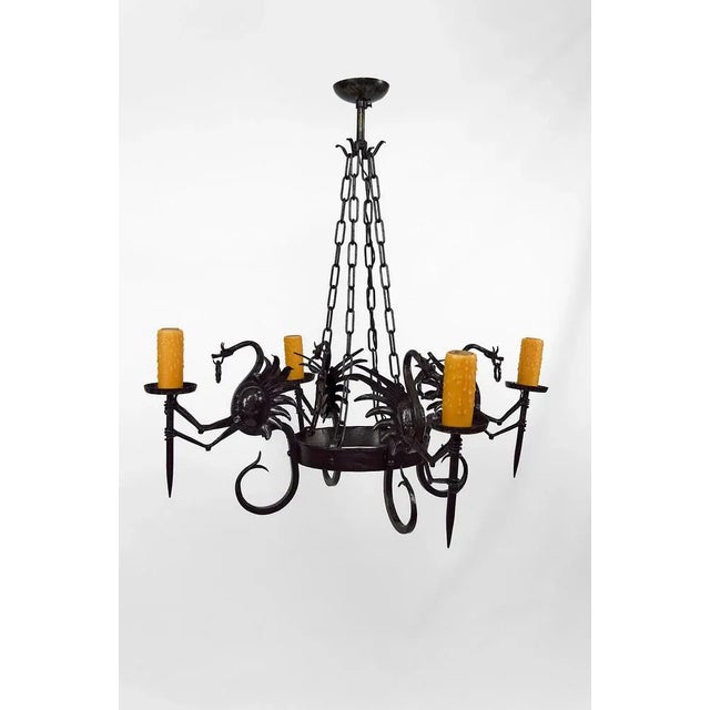 Superb wrought iron chandelier / pendant composed of 4 winged dragons each holding a torch / torchiere. Good quality of...