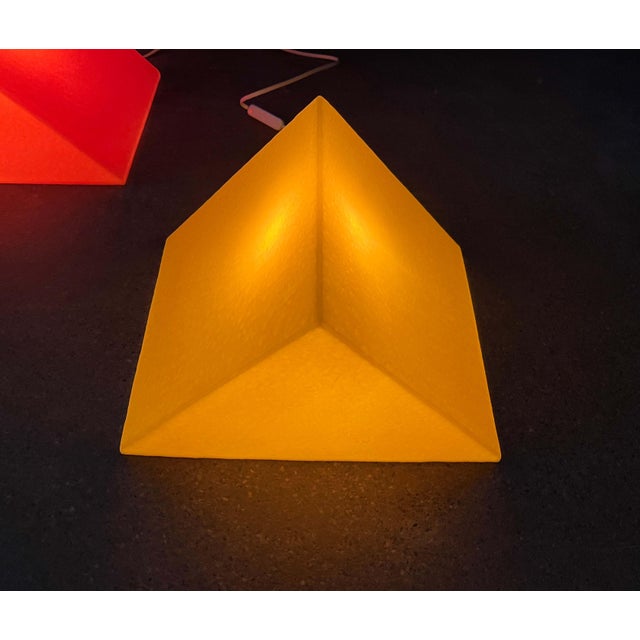 Postmodern prism-shaped floor/table lamp by Heico. Shown here in yellow. These lamps feature the graphic form of a prism....