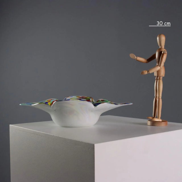 Elongated centerpiece in white and submerged glass, with multi-colored and gold inclusion decorations. This piece is...