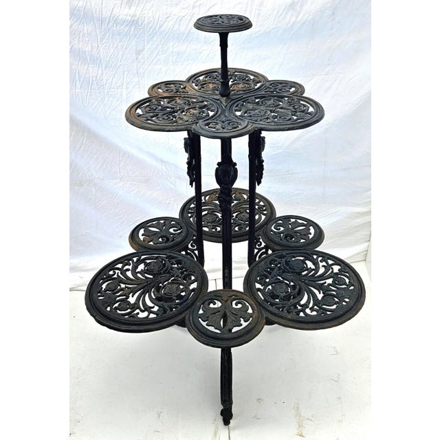 Victorian-style three-tiered cast iron plant stand. This ornate and beautifully detailed stand rests on three feet of...