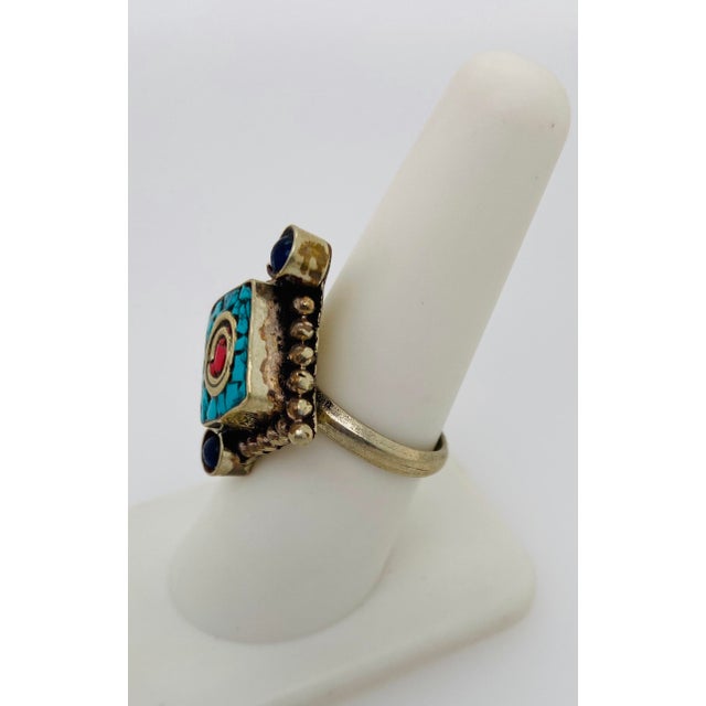 This vintage Moroccan tribal ring from the 1950s is a bold expression of cultural artistry and symbolic design. Crafted in...