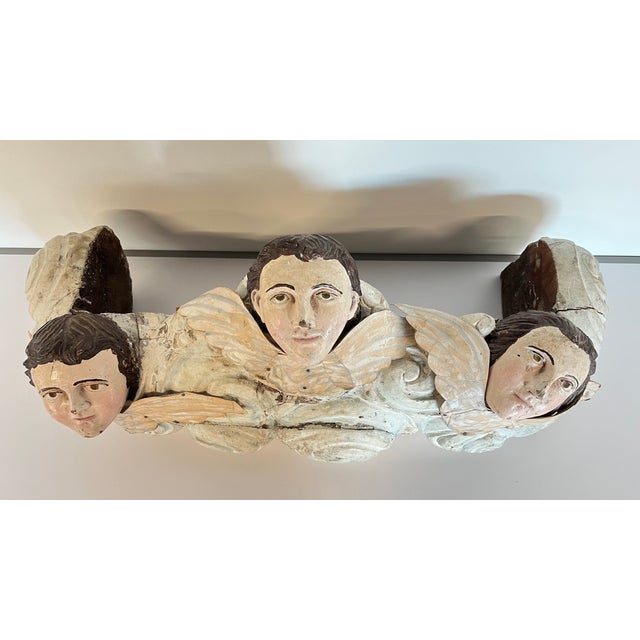 These wood carved cherub angels faces were at one time part of the base of an 18th Century Santos. Santos, in the context...