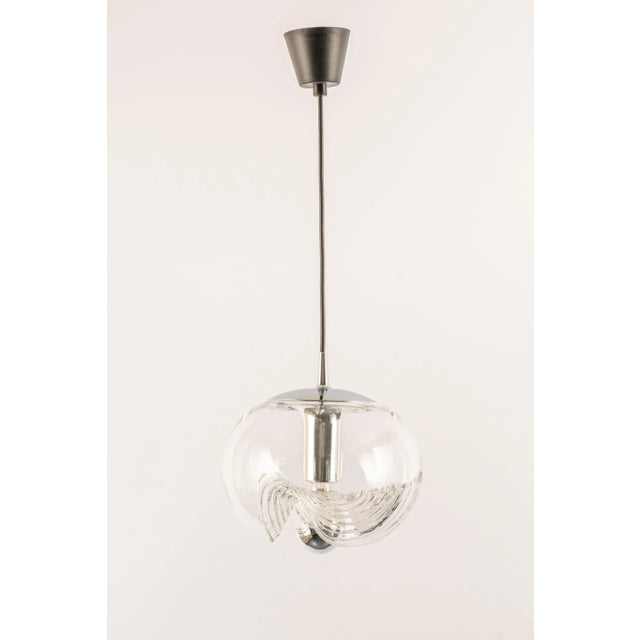 A special round biomorphic clear glass pendant designed by koch & lowy for peill & putzler, manufactured in germany, circa...