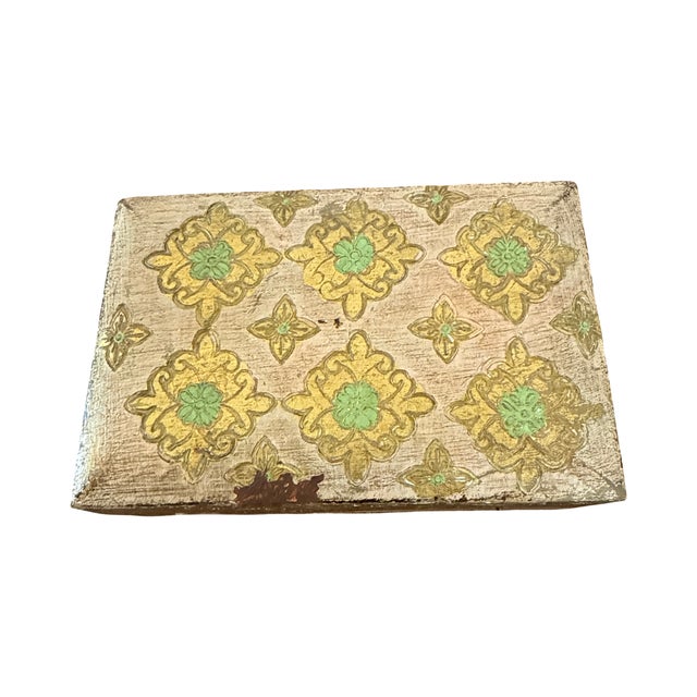 An elegant vintage Italian Florentine keepsake box crafted of wood and decorated with hand-painted gilt floral motifs and...