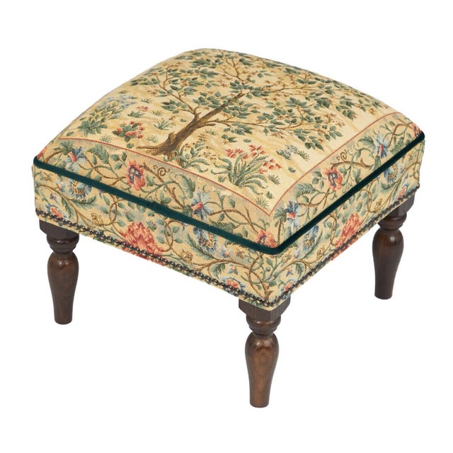 Meticulously handcrafted in the United Kingdom, this upholstered stool boasts classic studding and hand-polished solid...