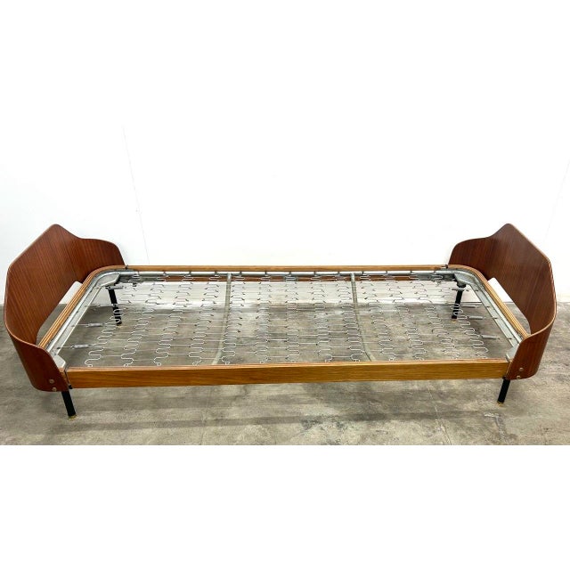 Daybed by Franco Campo and Carlo Graffi, "Home" series, circa 1960. Curved plywood, brass inserts, black-painted iron legs...