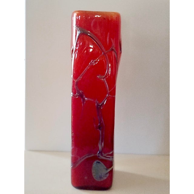 A cubic vase entirely handmade, free-blown in three layers of glass. Embellished with silver nitrate filaments, this piece...