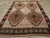 This mid-20th century Turkish Anatolian tribal carpet, measuring 7' 5" x 10' 4", presents a bold, symmetrical composition...