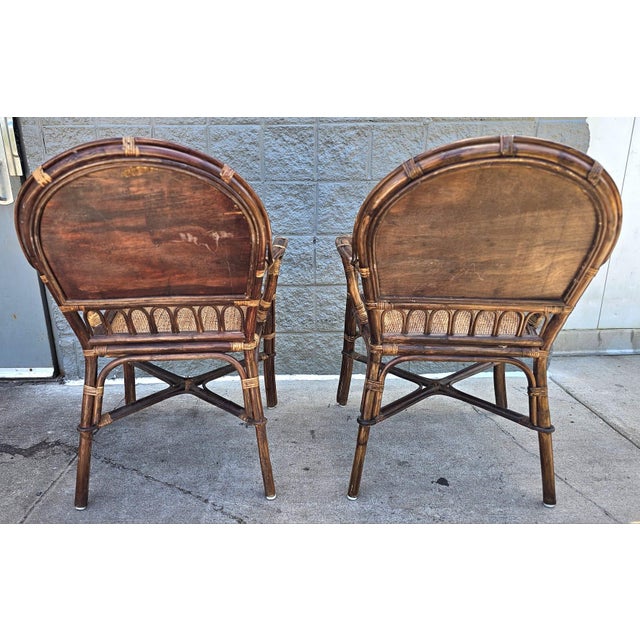 A Pair of Mid Century Rattan and Padded Pattern of Brown Woven Reed Seat and Back Armchairs. Measures 26 " in width, 24"...