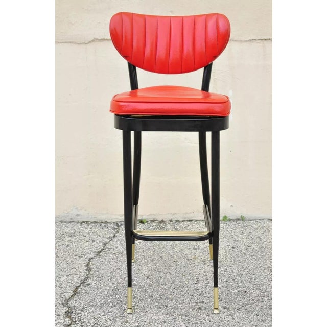 Vintage Mid Century Black Metal Red Vinyl Italian Style Barstool by Lion Brand . Item features red vinyl upholstery, metal...